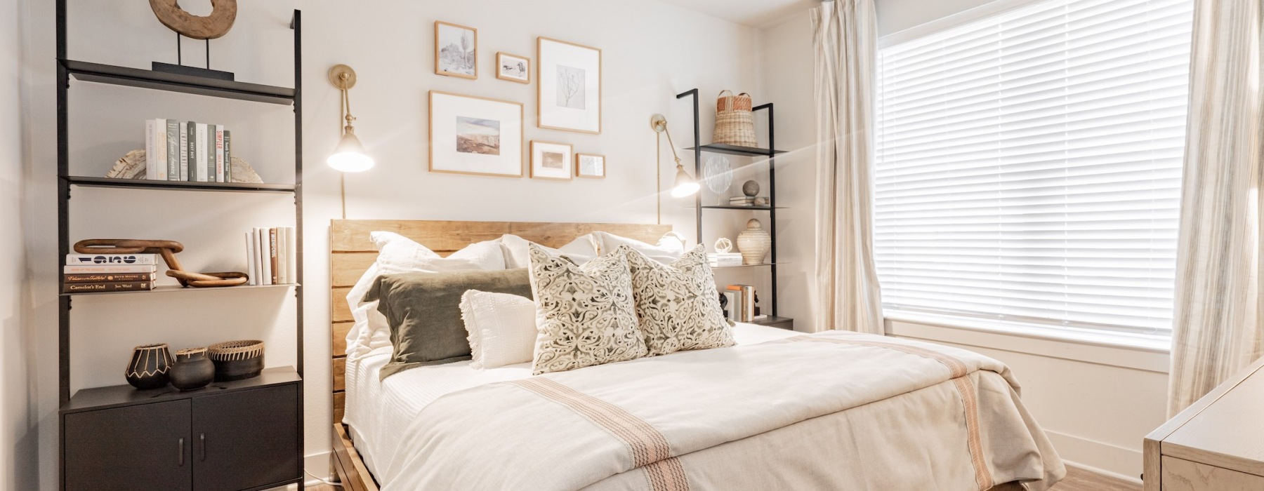 a bedroom with a bed and a shelf with books