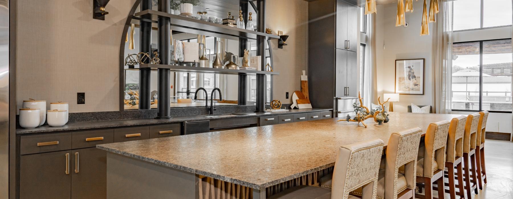 a kitchen with a bar and chairs