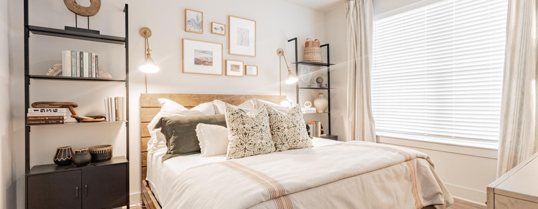 a bedroom with a bed and a shelf with books