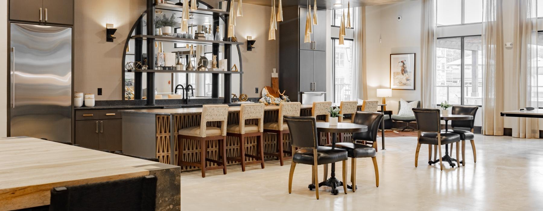 a large kitchen with tables and chairs and an island