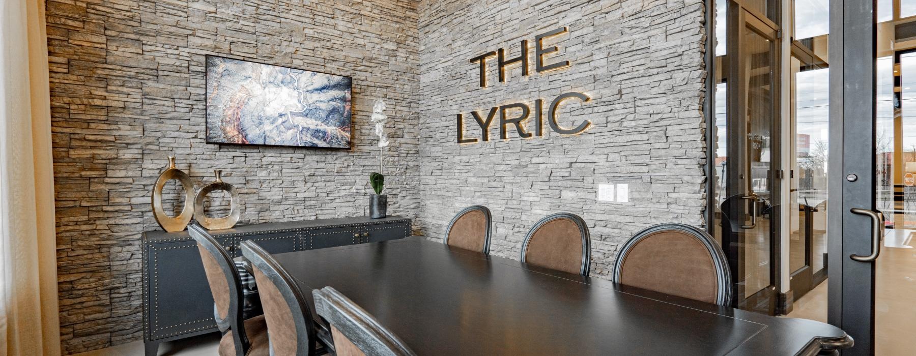 a table with chairs around it and a sign on a wall